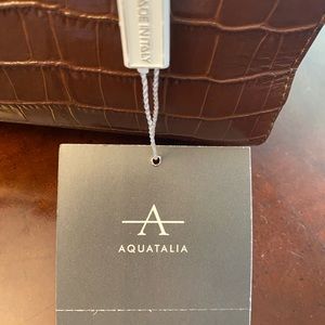 Brand new handbag. Italian leather. Includes long strap.